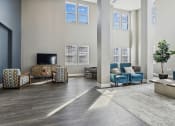 Thumbnail 5 of 22 - a living room with blue chairs and a tv