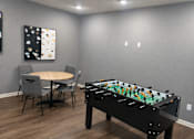 Thumbnail 2 of 7 - A pool table is in the middle of a room with a table and chairs.