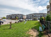 Thumbnail 10 of 31 - Dog park with a bench at Mosaic Apartments in Avon, Indiana