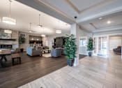 Thumbnail 2 of 31 - Clubhouse with with a plant and couches in the background at Mosaic Apartments in Avon, Indiana