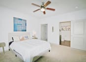 Thumbnail 23 of 31 - a bedroom with a large white bed and a ceiling fan
