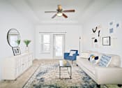 Thumbnail 19 of 31 - a living room with a white couch and a ceiling fan