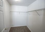 Thumbnail 13 of 13 - A white room with a door and a shelf.