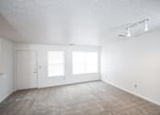 Thumbnail 9 of 13 - A room with a carpeted floor and white walls.