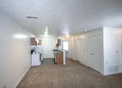 Thumbnail 7 of 13 - A kitchen area with white appliances and cabinets.