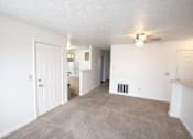 Thumbnail 8 of 13 - A spacious room with a carpeted floor and a ceiling fan.