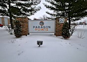 Thumbnail 4 of 13 - A sign that says Paragon Pointe stands in the snow.