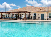 Thumbnail 2 of 34 - The pool and exterior clubhouse at the Flats at Sundown in North Port, Florida