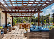 Thumbnail 5 of 34 - The picnic area with pergola, tiki bar, and chairs at the Flats at Sundown in North Port, Florida