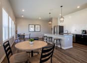 Thumbnail 16 of 31 - Clubhouse kitchen with tables, chairs, and appliances in the background