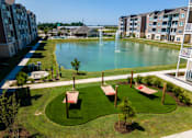 Thumbnail 1 of 31 - Aerial view of the community hammocks and pond at Promenade Luxury apartments