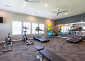 Thumbnail 19 of 31 - Fitness center with treadmills, a rower, and bench