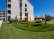 Thumbnail 7 of 31 - hammock area sitting on green grass with an apartment building in the background
