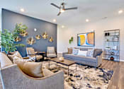 Thumbnail 15 of 31 - a living room with couches and chairs and a blue accent wall
