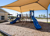 Thumbnail 13 of 31 - a playground with two slides and a swing set