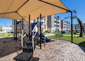 Thumbnail 12 of 31 - Playground with a slide under a canopy