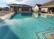 Thumbnail 6 of 31 - swimming pool with clubhouse in the background