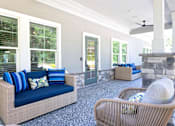 Thumbnail 29 of 44 - A patio with a couch, chair, and pillows.
