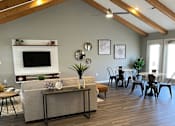 Thumbnail 2 of 11 - Clubhouse lounge area with couch and table at Canterbury House Apartments in Columbus Indiana