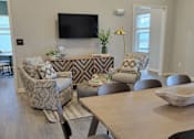 Thumbnail 4 of 28 - a living room with a table and chairs at Southern Meadows apartments