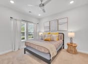 Thumbnail 46 of 57 - a bedroom with a bed and a ceiling fan