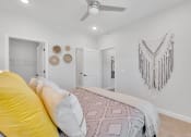 Thumbnail 54 of 57 - a bedroom with a bed and a ceiling fan