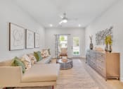 Thumbnail 56 of 57 - a living room with furniture and a ceiling fan