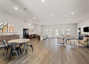 Thumbnail 14 of 25 - A spacious living room with a dining table and chairs.