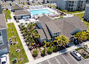 Thumbnail 47 of 83 - an aerial view of swiftwater apartments  with a pool in the middle.