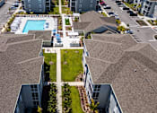 Thumbnail 50 of 83 - A bird's eye view of a residential area with houses, cars, and a swimming pool.