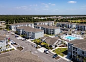 Thumbnail 51 of 83 - an aerial view of swiftwater apartments  with a pool in the middle.