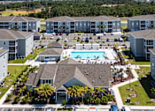 Thumbnail 46 of 83 - A large apartment complex with a swimming pool in the center.