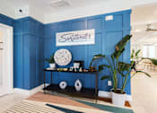 Thumbnail 68 of 83 - A room with a blue wall and a sign for swiftwater apartments