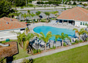 Thumbnail 3 of 22 - Aerial view of pool and clubhouse at Trillium apartments in Melbourne fl