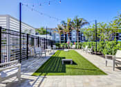 Thumbnail 13 of 96 - A patio with white furniture and a black fence.