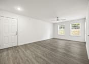 Thumbnail 4 of 33 - A room with a white door and a ceiling fan.