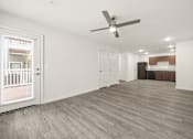 Thumbnail 2 of 33 - A room with a ceiling fan and wooden flooring.