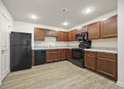 Thumbnail 1 of 33 - A kitchen with black appliances and wooden cabinets.