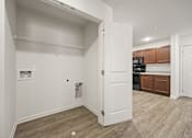 Thumbnail 3 of 33 - A white door is open to a kitchen area.
