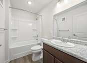 Thumbnail 10 of 33 - A white bathroom with a toilet, sink, and bathtub.