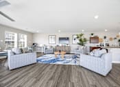 Thumbnail 29 of 33 - A modern living room with a grey sofa set and a wooden floor.