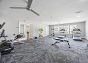 Thumbnail 19 of 33 - A spacious gym with a variety of exercise equipment.