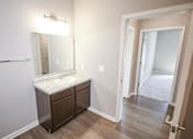 Thumbnail 15 of 15 - A bathroom with a sink and mirror.
