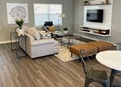 Thumbnail 3 of 11 - Clubhouse lounge area with couch and table at Canterbury House Apartments in Columbus Indiana