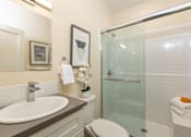 Thumbnail 10 of 31 - A bathroom with a sink, toilet, and shower.
