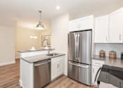 Thumbnail 6 of 31 - A modern kitchen with stainless steel appliances and white cabinets.