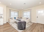 Thumbnail 1 of 31 - A living room with a grey sofa and a grey rug.