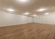 Thumbnail 14 of 31 - A room with wooden flooring and white walls.