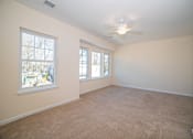Thumbnail 8 of 12 - a bedroom with a ceiling fan and three windows