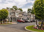 Thumbnail 1 of 12 - a row of houses with cars parked in front of them